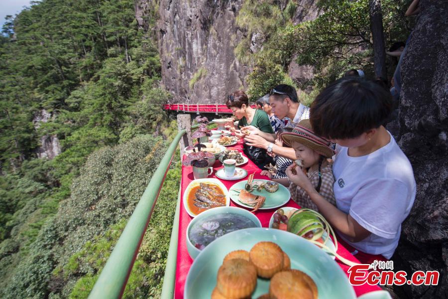 A view of a restaurant built on a cliff at Longquan Mountain in Zhejiang Province, Sept. 19, 2018. Over 100 tourists became the first customers of the newly opened restaurant and had food on suspended plank roads while enjoying the great view of the mountain. Longquan is the highest peak in the Yangtze River Delta. (Photo: China News Service/Yang Chen)