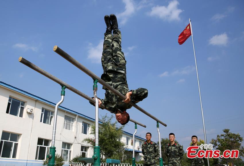 Armed police Kang Liming shows his skills on parallel bars in Meihekou City, Northeast China’s Jilin Province. The Kang brothers joined the army together and have won a number of awards although they have different personalities and gifts. (Photo: China News Service/Liang Yonggang)