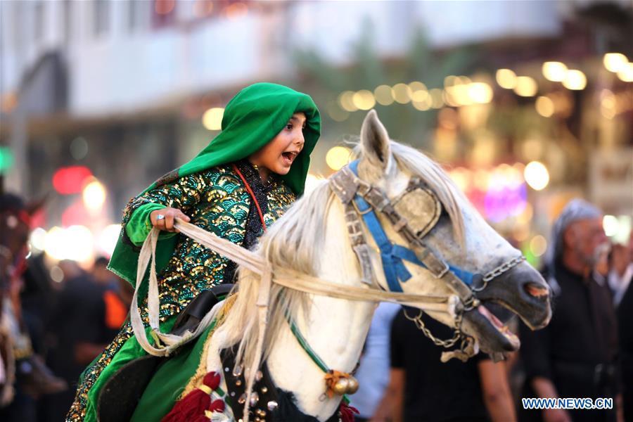 A girl participates in the celebration of upcoming Ashura in Baghdad, Iraq, Sept. 19, 2018. Ashura, the 10th day of the Islamic month of Muharram, marks the martyrdom of Imam Hussein, the grandson of Prophet Mohammad, in the battle of Kerbala in Iraq in the year 680. (Xinhua/Khalil Dawood)