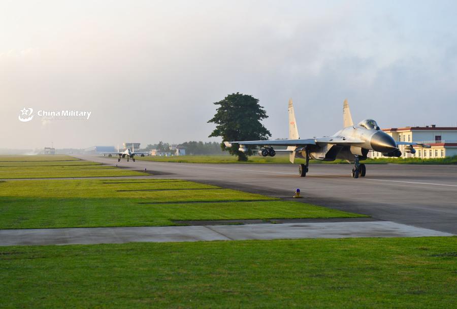 Two J-11B fighter jets attached to an aviation brigade of the South China Sea Fleet under the PLA Navy taxi on the runway before takeoff for a live-fire flight training exercise at a shooting range near the South China Sea on September 19, 2018. (Photo/eng.chinamil.com.cn)