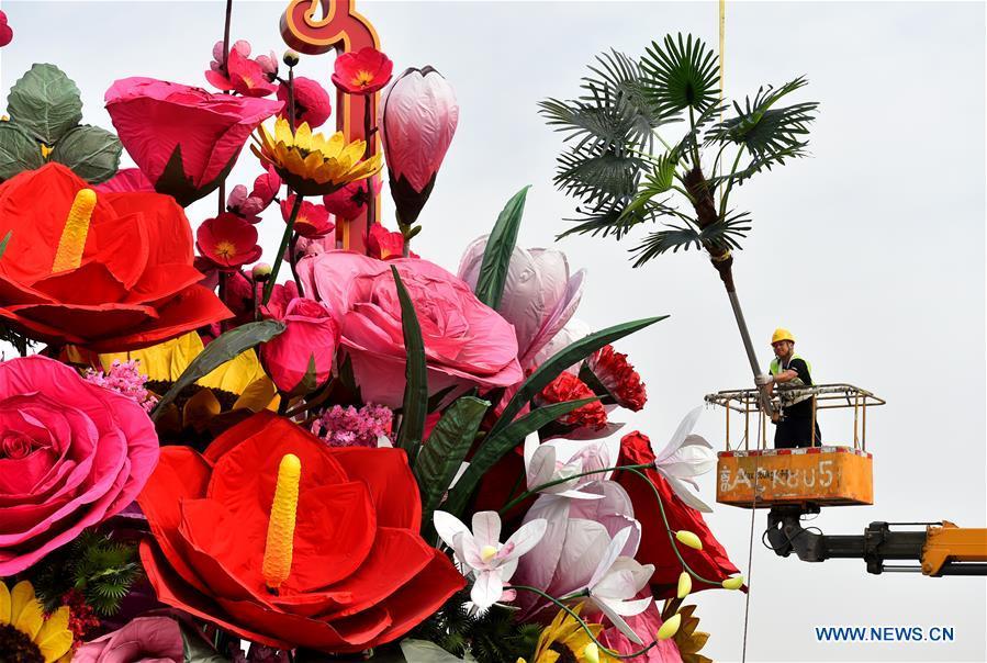 A constructor decorates an artificial flower basket at the Tiananmen Square in Beijing, capital of China, Sept. 20, 2018. A 17-meter-tall installation in the shape of a flower basket with a diameter of 50 meters at the bottom is placed at the center of the Tiananmen Square as a decoration for China\'s upcoming National Day holiday. (Xinhua/Luo Xiaoguang)