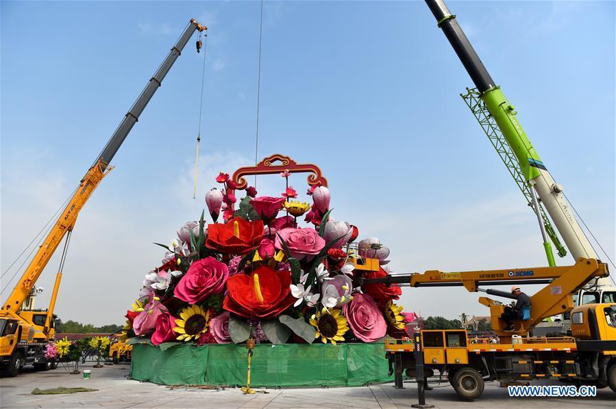 An artificial flower basket is placed at the Tiananmen Square in Beijing, capital of China, Sept. 20, 2018. A 17-meter-tall installation in the shape of a flower basket with a diameter of 50 meters at the bottom is placed at the center of the Tiananmen Square as a decoration for China\'s upcoming National Day holiday. (Xinhua/Luo Xiaoguang)