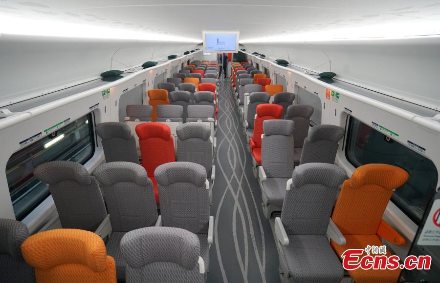 A view of the compartment for second-class seats in the high-speed train used for the Guangzhou-Shenzhen-Hong Kong Express Rail Link, Sept. 23, 2018. The second-class seats feature different colors and a wavelike pattern on the floor. Folding seat and magazine holders are provided for passengers. The backrest of each seat is adjustable. (Photo: China News Service/Zhang Wei)