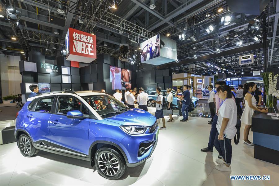 Visitors look at exhibits at the Future of Transportation World Conference in Hangzhou, east China\'s Zhejiang Province, Sept. 20, 2018. (Xinhua)