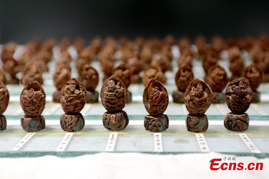 Cai Qingzhu’s nut carvings featuring the 108 characters in the Chinese novel Water Margin is displayed at an exhibition in a museum in Xi’an City, Northwest China’s Shaanxi Province, Sept. 25, 2018. It took Cai, 55, two years to finish the carvings. Nut carving, the miniature folk art of carving fruit and nut pits, has been practiced in China for centuries. (Photo: China News Service/Zhang Yuan)