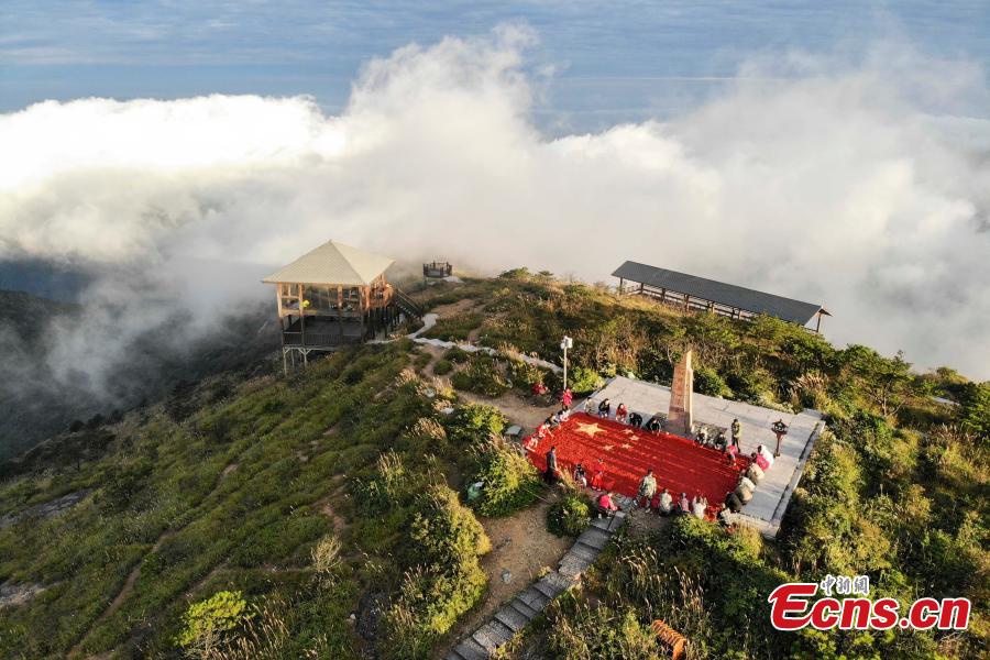 Farmers use eight tons of freshly-harvested peppers and corn to create a giant national flag on the top of Longquan Mountain in Zhejiang Province, Sept. 26, 2018, as part of harvest celebrations. The flag measured 10 meters in length and was 6.6 meters wide. The mountain is the highest peak in the Yangtze River Delta. (Photo: China News Service/Yang Yong)