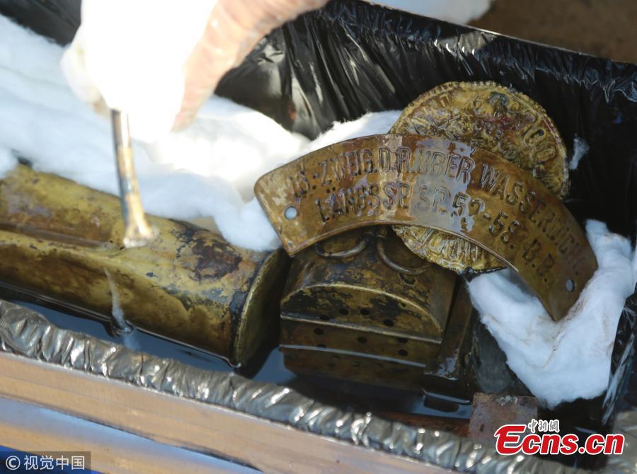 Relics found from the warship Jingyuan, sunk by the Japanese navy during the Sino-Japanese War (1894-1895), at a beach in Zhuanghe City, Northeast China’s Liaoning Province, Sept. 25, 2018. Underwater investigation found more than 500 items made of iron, glass, porcelain, leather and other materials. Archeologists identified the shipwreck from a plate carrying the warship\'s name after it was found on the seabed 12 meters underwater with its main body covered in sludge on Sept. 15. (Photo/VCG)