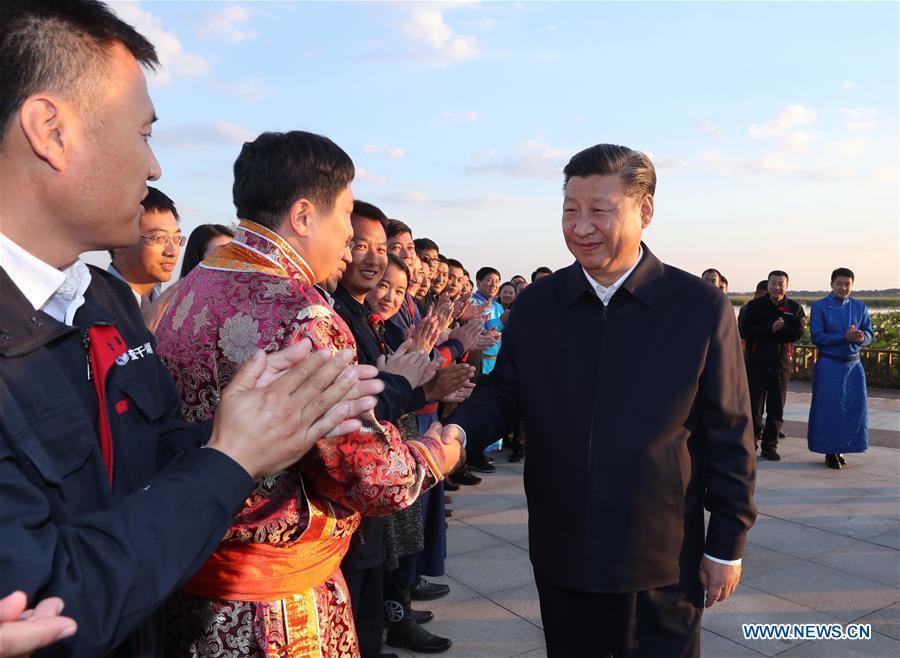 Chinese President Xi Jinping, also general secretary of the Communist Party of China (CPC) Central Committee and chairman of the Central Military Commission, meets with local residents by the Chagan Lake in Songyuan, northeast China\'s Jilin Province, Sept. 26, 2018. Xi inspected Songyuan on Wednesday. (Xinhua/Ju Peng)