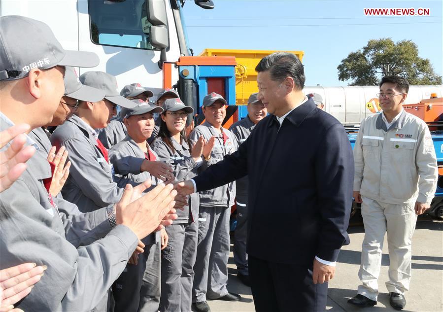 Chinese President Xi Jinping, also general secretary of the Communist Party of China (CPC) Central Committee and chairman of the Central Military Commission, shakes hands with workers during his visit to China Railway Rolling Stock Corporation (CRRC) Qiqihar Co. in Qiqihar, northeast China\'s Heilongjiang Province, Sept. 26, 2018. Xi inspected Qiqihar on Wednesday. (Xinhua/Ju Peng)