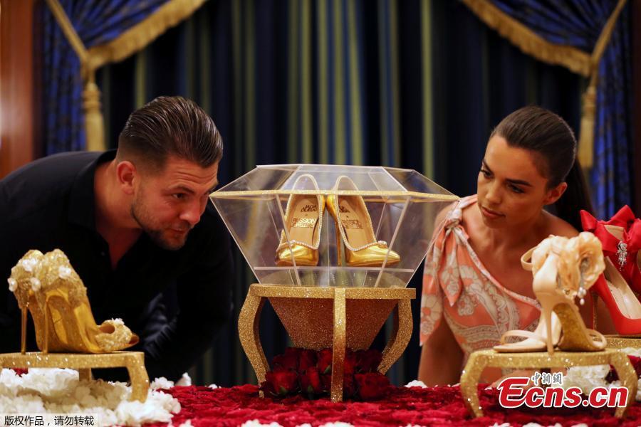 Touted as the world\'s most expensive footwear at $17 million, the Passion Diamond shoes is on display alongside Jada Dubai\'s newly launched collection of jewelled shoes at Burj Al Arab, Dubai, Sept. 26, 2018. Made in collaboration with Dubai\'s Passion Jewellers, the Passion Diamond pair are crafted from real gold, while a D-flawless 15-carat diamond adorns the toe of each stiletto. A total of 236 diamonds line the opening of the shoe where it meets the foot.(Photo/Agencies)