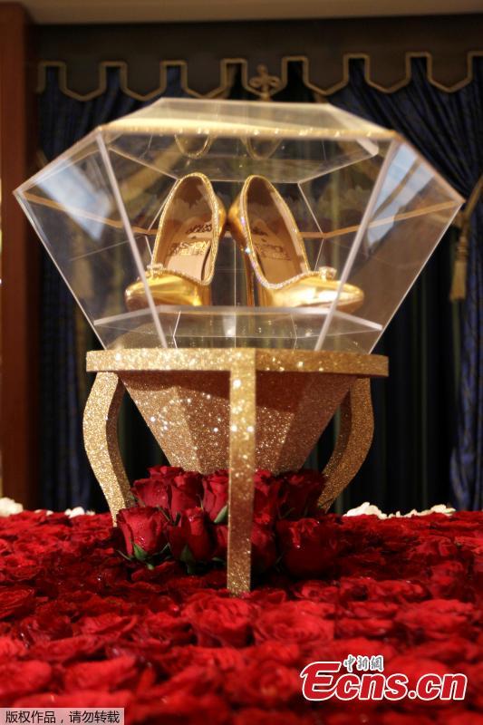 Touted as the world\'s most expensive footwear at $17 million, the Passion Diamond shoes is on display alongside Jada Dubai\'s newly launched collection of jewelled shoes at Burj Al Arab, Dubai, Sept. 26, 2018. Made in collaboration with Dubai\'s Passion Jewellers, the Passion Diamond pair are crafted from real gold, while a D-flawless 15-carat diamond adorns the toe of each stiletto. A total of 236 diamonds line the opening of the shoe where it meets the foot.(Photo/Agencies)