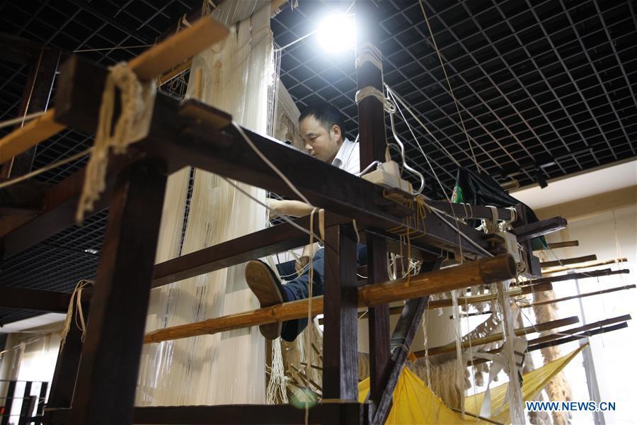 A weaver knits Yun brocade at the Nanjing Yunjin Museum in Nanjing, capital of east China\'s Jiangsu Province, Sept. 26, 2018. Yunjin, also called Yun brocade, is traditional Chinese silk brocade made in Nanjing of Jiangsu. Dated from the Eastern Jin Dynasty, it has formed its own characteristics through its development of 1,600 years. Yun brocade is famous for its exquisite craft, elegant patterns and smooth texture, and the making of the artwork requires close cooperation of two weavers, who can produce only five centimeters a day. In 2009, Yun brocade was inscribed on the Representative List of the Intangible Cultural Heritage of Humanity. (Xinhua/Zhu Weixi)