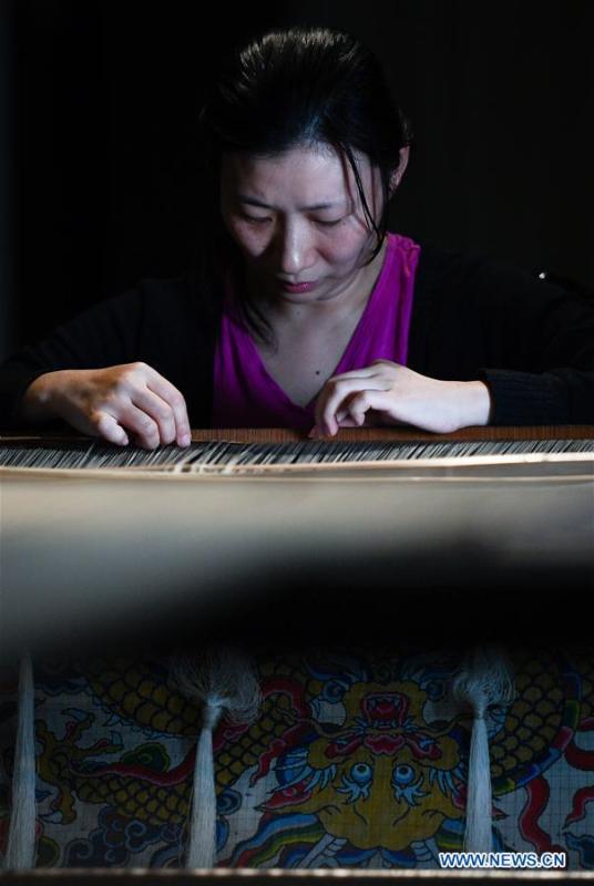 A weaver shows skills of knitting Yun brocade at the Nanjing Yunjin Museum in Nanjing, capital of east China\'s Jiangsu Province, Sept. 26, 2018. Yunjin, also called Yun brocade, is traditional Chinese silk brocade made in Nanjing of Jiangsu. Dated from the Eastern Jin Dynasty, it has formed its own characteristics through its development of 1,600 years. Yun brocade is famous for its exquisite craft, elegant patterns and smooth texture, and the making of the artwork requires close cooperation of two weavers, who can produce only five centimeters a day. In 2009, Yun brocade was inscribed on the Representative List of the Intangible Cultural Heritage of Humanity. (Xinhua/Li Xiang)