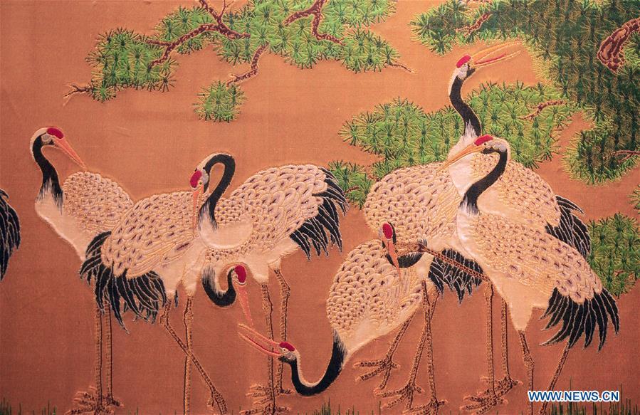 Photo taken on Sept. 26, 2018 shows a Yun brocade product at the Nanjing Yunjin Museum in Nanjing, capital of east China\'s Jiangsu Province. Yunjin, also called Yun brocade, is traditional Chinese silk brocade made in Nanjing of Jiangsu. Dated from the Eastern Jin Dynasty, it has formed its own characteristics through its development of 1,600 years. Yun brocade is famous for its exquisite craft, elegant patterns and smooth texture, and the making of the artwork requires close cooperation of two weavers, who can produce only five centimeters a day. In 2009, Yun brocade was inscribed on the Representative List of the Intangible Cultural Heritage of Humanity. (Xinhua/Sui Xiankai)