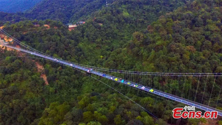 A drone photo shows a 379-meter-long glass bridge built in the Nandan Mountain area in Foshan City, South China’s Guangdong Province, which opened on Sept. 28, 2018 after passing safety test. The glass bridge, suspended 202 meters above the ground, makes use of innovative technology to create impressive sound and visual effects. (Photo: China News Service/Zeng Linghua)