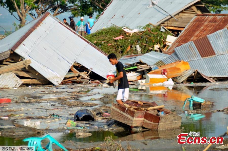 A man surveys the damage caused by earthquake and tsunami in Palu, Central Sulawesi, Indonesia, Saturday, Sept. 29, 2018. The powerful earthquake rocked the Indonesian island of Sulawesi on Friday, triggering a tsunami that an official said swept away houses in at least two cities.