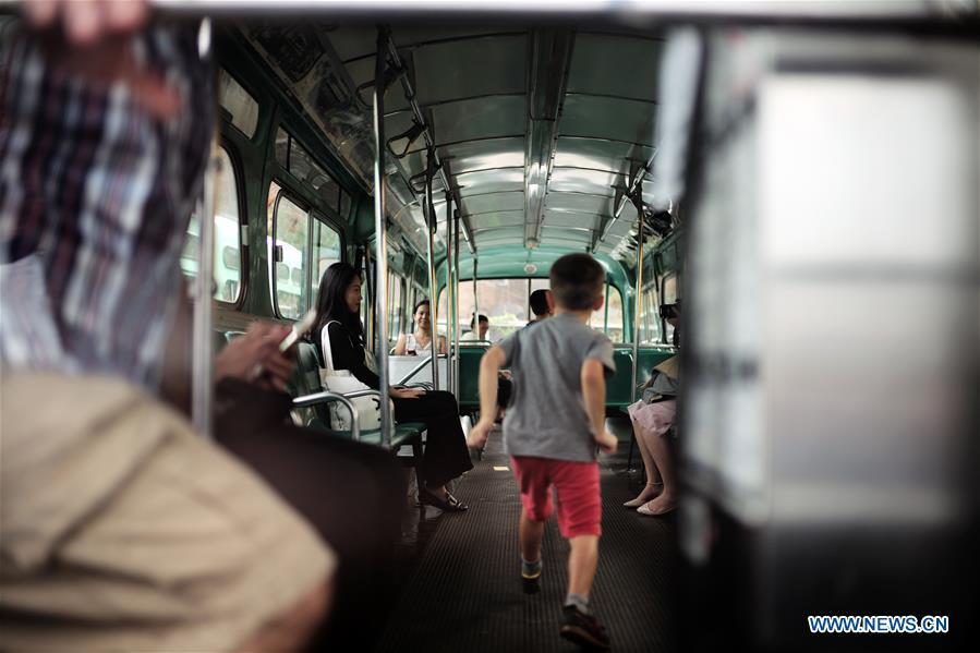 People visit a vintage bus during the 25th Annual Bus Festival in New York, the United States, on Oct. 7, 2018. The New York Transit Museum held its 25th annual bus festival on Sunday. The buses on display represent about 80 years of surface transit history in New York City. The oldest bus at the festival, Bus 1263, is a double-decker bus that was purchased by the Fifth Avenue Bus Company in 1930. (Xinhua/Li Muzi)