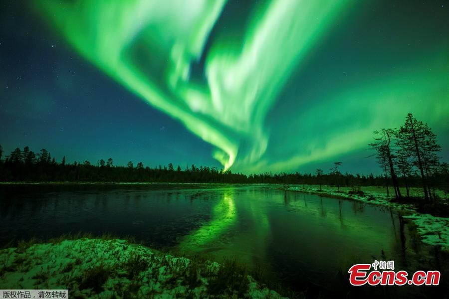 The Aurora Borealis (Northern Lights) is seen over the sky near Rovaniemi in Lapland, Finland, October 7, 2018. The Northern Lights moved in the sky with bright green arches reflected in frozen lake. (Photo/Agencies)