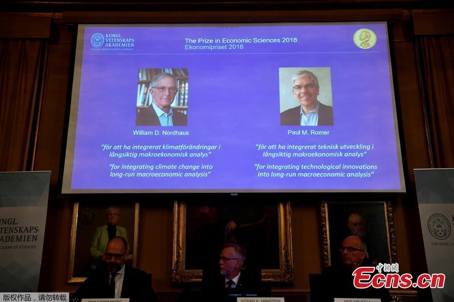 A screen displays the portraits of awarded economists William Nordhaus (L) and Paul Romer of the United States, in Stockholm, Sweden, Oct. 8, 2018. The 2018 Nobel Prize in Economics was awarded Monday jointly to William Nordhaus and Paul Romer. (Photo/Agencies)