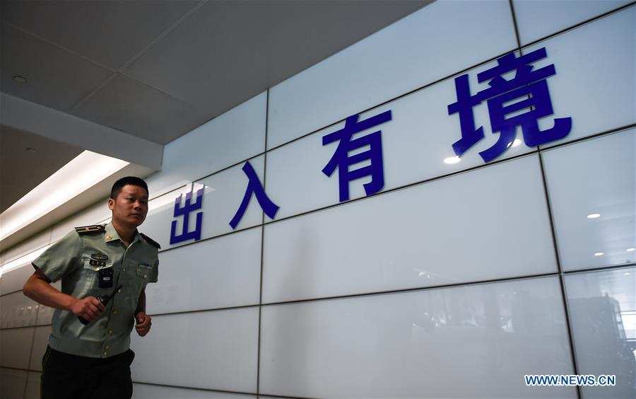 Wang Zhiguo is seen at an inspection station of Nanjing Lukou International Airport in Nanjing, capital of east China\'s Jiangsu Province, Aug. 7, 2018. Wang Jicai, who used to be head of the militia post on Kaishan Island in Jiangsu Province, started working on the island in the Yellow Sea with his wife in 1986. He died of sudden illness while on duty in July of 2018 at the age of 58. Wang Zhiguo, son of Wang Jicai, became a frontier defence policeman after his graduation from Nanjing University of Aeronautics and Astronautics in 2013. He had been assigned to many security tasks for major events during 5 years\' working. (Xinhua/Li Xiang)
