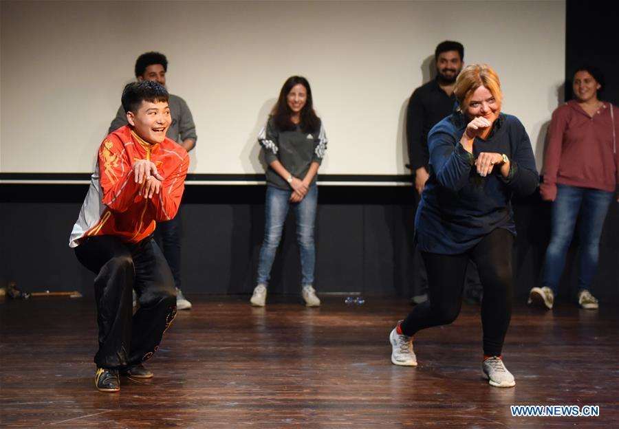 Shi Longlong (L, Front), a teacher of the Beijing-based Capital University of Physical Education and Sports, teaches a Turkish woman Kung Fu moves in Bogazici University of Istanbul, Turkey, on Oct. 9, 2018. A charm of Chinese Kung Fu tour started on Tuesday evening at Bogazici University in Istanbul, enchanting the audience with a mixture of Chinese martial arts and dances. (Xinhua/He Canling)