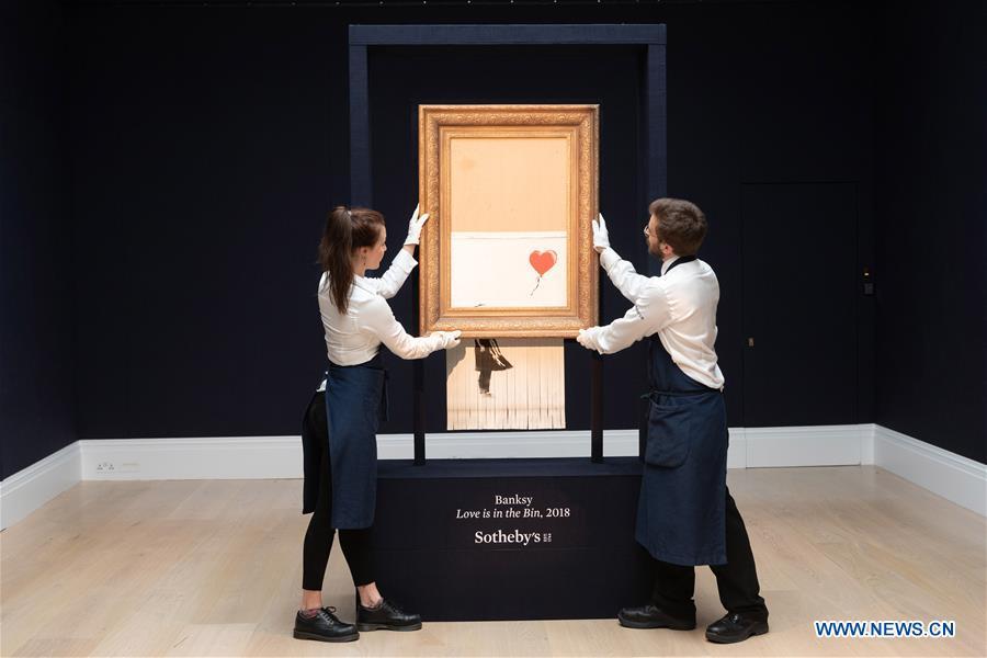 Sotheby\'s staff members present Banksy\'s \