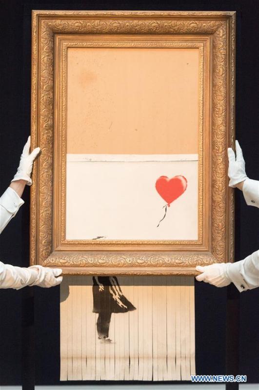 Sotheby\'s staff members present Banksy\'s \
