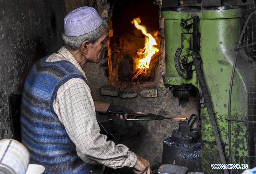 A craftsman makes horseshoes in Kashgar City, northwest China\'s Xinjiang Uygur Autonomous Region, Oct. 16, 2018. The ancient oasis city of Kashgar, in the westernmost part of China near the border with Kyrgyzstan, Tajikistan, Afghanistan, and Pakistan, was an important staging post on the original Silk Road and has been revitalized as a bustling hub of business and different cultures. (Xinhua/Li Zhihao)