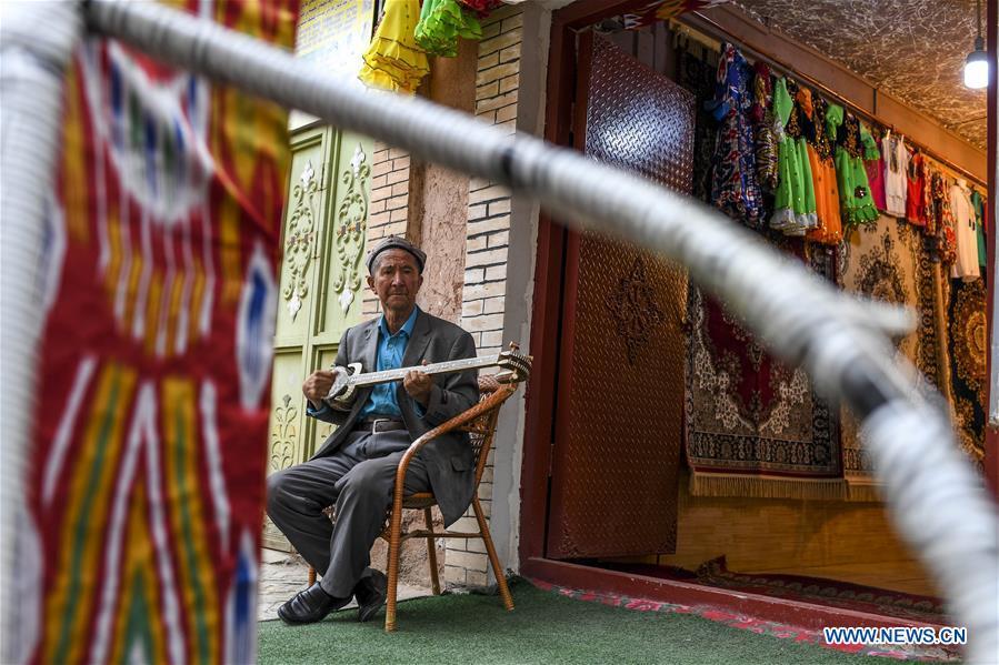 A man plays a traditional musical instrument at home in Kashgar City, northwest China\'s Xinjiang Uygur Autonomous Region, Oct. 16, 2018. The ancient oasis city of Kashgar, in the westernmost part of China near the border with Kyrgyzstan, Tajikistan, Afghanistan, and Pakistan, was an important staging post on the original Silk Road and has been revitalized as a bustling hub of business and different cultures. (Xinhua/Hu Huhu)