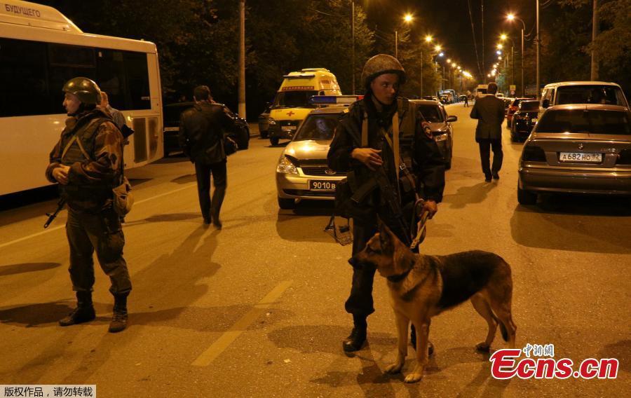 Law enforcement officers stand guard near the scene of a fatal attack on a college in the port city of Kerch, Crimea, Oct. 17, 2018. At least 19 people have been killed and dozens injured in a mass shooting at the college. (Photo/Agencies)