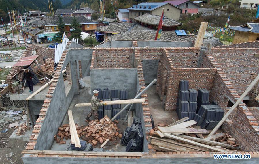 In this aerial photo taken on Oct. 18, 2018, villagers rebuild their home within the Jiuzhaigou Valley Scenic Area in Jiuzhaigou County of southwest China\'s Sichuan Province. The magnitude-7.0 earthquake that hit here on Aug. 8, 2017 and the flooding of this summer caused damages of various degrees to the Jiuzhaigou Valley Scenic Area, which has been temporarily closed since July for renovation. (Xinhua/Jiang Hongjing)
