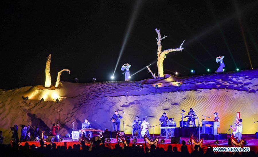 People play musical instruments during a desert themed concert held in Qiemo County in the Mongolian Autonomous Prefecture of Bayingolin, northwest China\'s Xinjiang Uygur Autonomous Region, Oct. 20, 2018. (Xinhua/Zhao Ge)