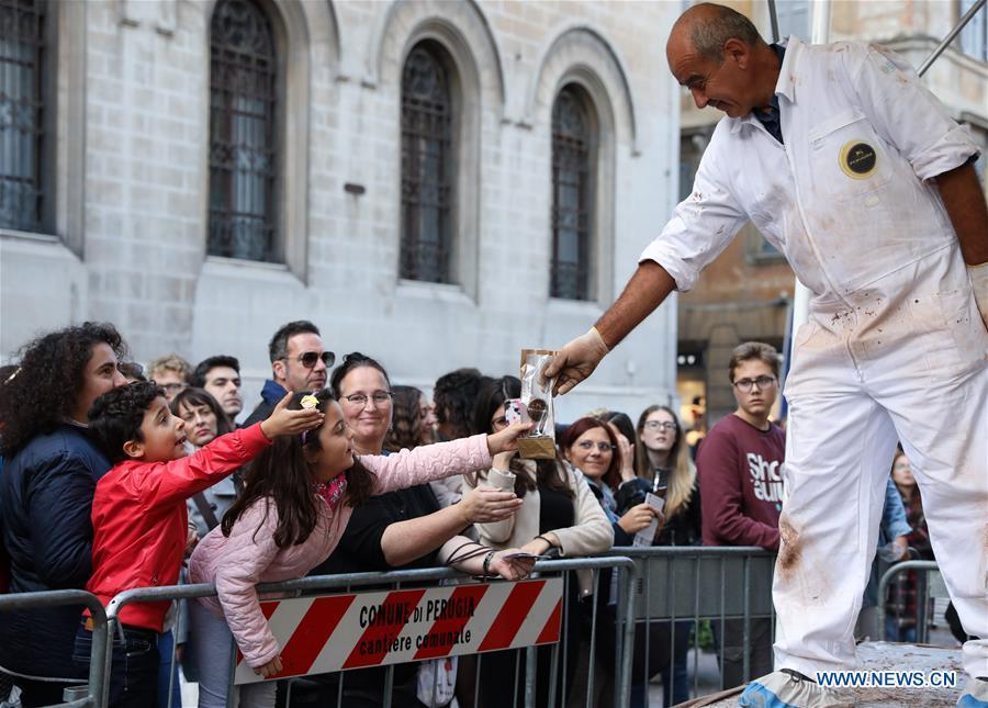 An artist gives chocolate chunks to a visitor during the 25th international chocolate festival \