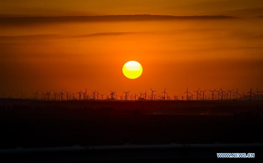 Photo taken on June 6, 2014 shows a wind power plant in Urumqi, northwest China\'s Xinjiang Uygur Autonomous Region. Xinjiang has seen a surge in the electricity generation from clean energy. According to State Grid Xinjiang Electric Power Co., Ltd., wind and solar power generated 27.81 billion and 9.07 billion kilowatt hours (kwh) of electricity, respectively, in the first nine months of 2018 in the region. With abundant wind and solar resources, Xinjiang is a pioneer in using new energy in China, with installed new-energy capacity having exceeded 27 million kilowatts so far. (Xinhua/Zhao Ge)