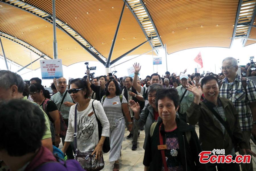 Passengers wait at the Passenger Clearance Building in Hong Kong to board coaches that will pass over the Hong Kong-Zhuhai-Macao Bridge, Oct. 24, 2018. (Photo: China News Service/Xie Guanglei)