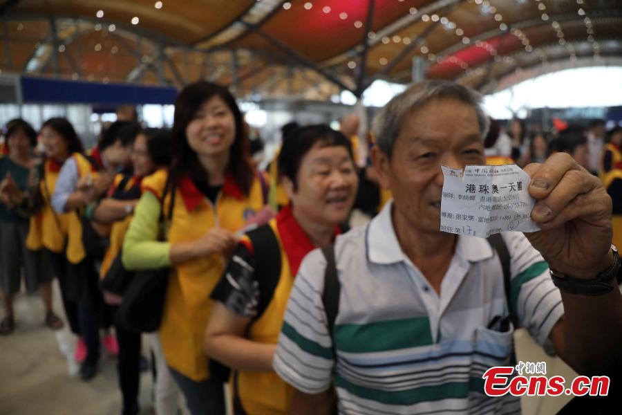 Passengers wait at the Passenger Clearance Building in Hong Kong to board coaches that will pass over the Hong Kong-Zhuhai-Macao Bridge, Oct. 24, 2018. (Photo: China News Service/Sheung Man Mak)