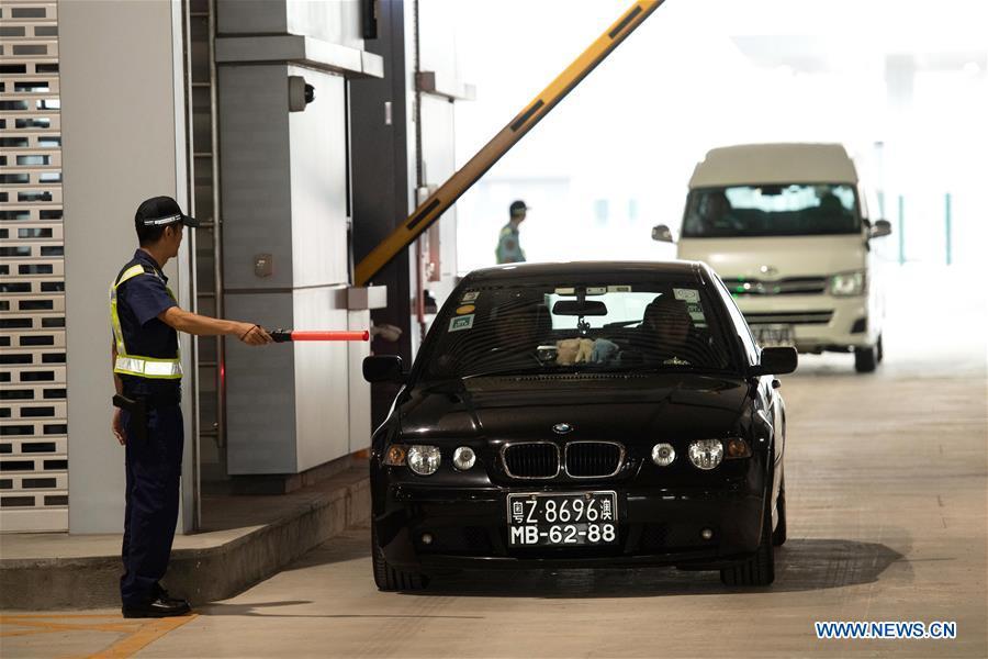 A private car goes through the Macao port of the Hong Kong-Zhuhai-Macao Bridge, Oct. 24, 2018. The Hong Kong-Zhuhai-Macao bridge, the world\'s longest cross-sea bridge, opened to public traffic at 9 a.m. Wednesday. (Xinhua/Cheong Kam Ka)