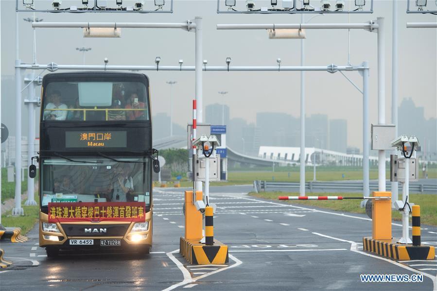 A shuttle bus arrives at the Macao port of the Hong Kong-Zhuhai-Macao Bridge in Macao, south China,Oct. 24, 2018. The Hong Kong-Zhuhai-Macao bridge, the world\'s longest cross-sea bridge, opened to public traffic at 9 a.m. Wednesday. (Xinhua/Cheong Kam Ka)