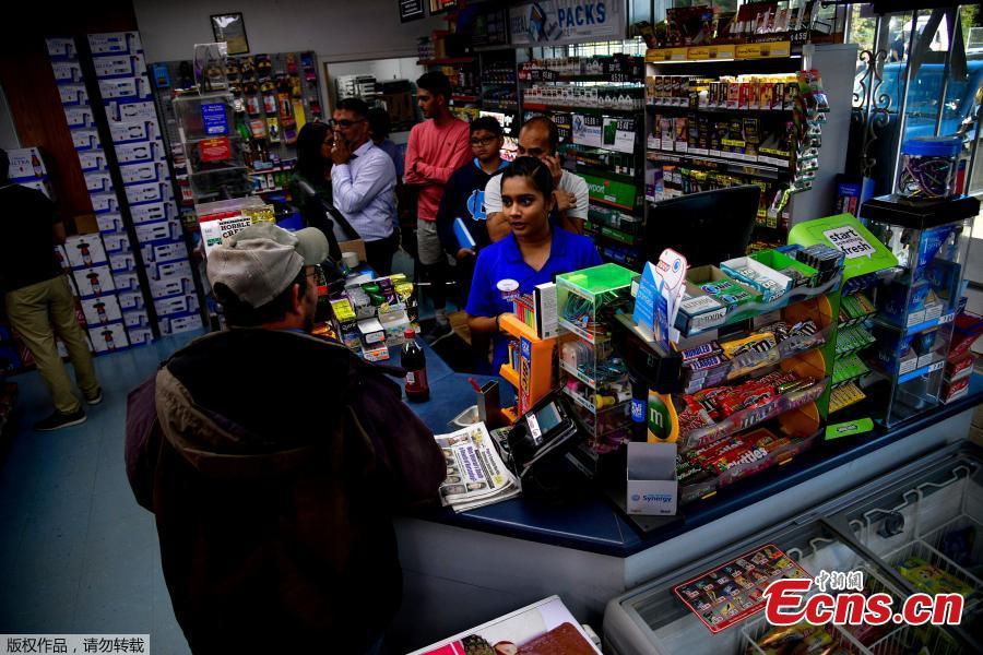 Twinkle Patel interacts with a regular customer at the KC Mart in Simpsonville, South Carolina, U.S., Oct. 24, 2018.(Photo/Agencies)