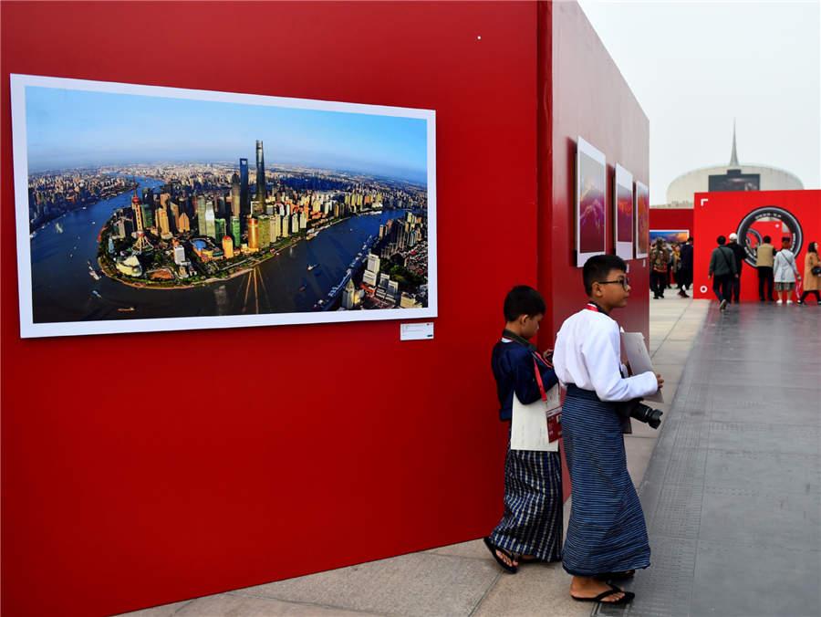 Visitors walk past a photography work displayed at Photo Beijing 2018 in Beijing, Oct. 20, 2018. (Photo/Xinhua)