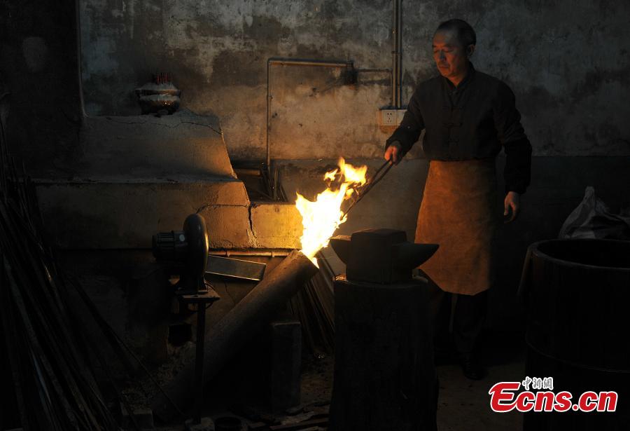 A sword-making workshop in Songxi County in East China’s Fujian Province. Zhanlu Mountain in southern Songxi, well-known for its long history and strong culture, is said to have been the home to the most revered among top five most famous swords in ancient China. Chinese poets in the Tang and Song dynasties, including Du Fu, Li Bai and Su Shi, penned lines in praise of the Zhanlu swords, nicknamed as the “No. 1 Sword Under the Heaven”. In 1985, local craftsmen went to huge efforts, reading historical literature and working with research institutes in Beijing and Nanjing, to finally craft Zhanlu swords by hand again. Making a Zhanlu sword involves more than 100 time-consuming steps, including forging, quenching and grinding. (Photo: China News Service/Zhang Bin)