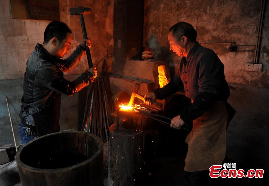 A sword-making workshop in Songxi County in East China’s Fujian Province. Zhanlu Mountain in southern Songxi, well-known for its long history and strong culture, is said to have been the home to the most revered among top five most famous swords in ancient China. Chinese poets in the Tang and Song dynasties, including Du Fu, Li Bai and Su Shi, penned lines in praise of the Zhanlu swords, nicknamed as the “No. 1 Sword Under the Heaven”. In 1985, local craftsmen went to huge efforts, reading historical literature and working with research institutes in Beijing and Nanjing, to finally craft Zhanlu swords by hand again. Making a Zhanlu sword involves more than 100 time-consuming steps, including forging, quenching and grinding. (Photo: China News Service/Zhang Bin)