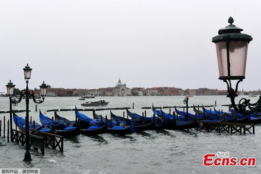 Gondolas are seen in the flooded Riva degli Schiavoni in front of the San Giorgio church during a high-water alert in Venice on October 29, 2018. The flooding, caused by a convergence of high tides and a strong Sirocco wind, reached around 150 centimetres on October 29. (Photo/Agencies)