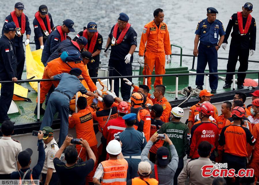 Rescue workers of Lion Air flight JT610 carry a body bag off a boat at Tanjung Priok port in Jakarta, Indonesia, Oct. 30, 2018. The search continued Tuesday for bodies and the \