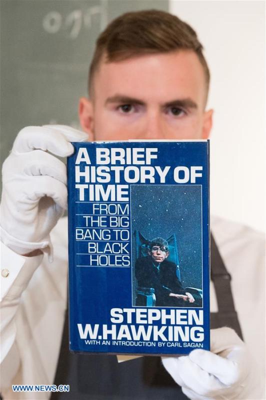 A staff member of auctioneer Christie\'s shows a book titled \