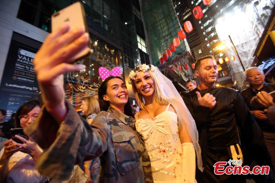 People dressed in Halloween costumes celebrate the western festival at Lan Kwai Fong in Hong Kong on October 31, 2018. (Photo: China News Service/Hong Shaokui)