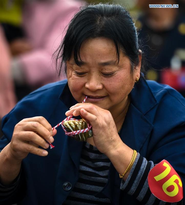 A woman takes part in a crab binding contest in Sihong County, east China\'s Jiangsu Province, Nov. 3, 2018. A total of 100 contestants participated in the event on Saturday. The winner bound 30 crabs within 3 minutes and 59 seconds. (Xinhua/Li Xiang)