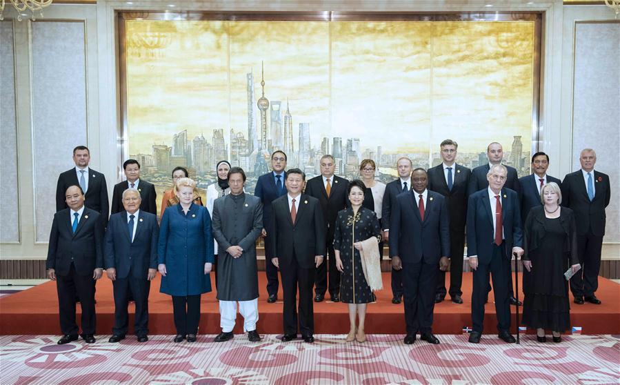 Chinese President Xi Jinping and his wife Peng Liyuan take group photos with foreign leaders and their spouses ahead of a banquet in Shanghai, east China, Nov. 4, 2018. Xi Jinping and his wife Peng Liyuan hosted a banquet on Sunday evening in Shanghai to welcome distinguished guests from around the world, who will attend the first China International Import Expo (CIIE) opening Monday. (Xinhua/Li Tao)