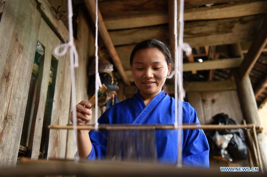 Yang Xinghe weaves at Xinjiang Village in Taijiang County of Qiandongnan Miao and Dong Autonomous Prefecture, southwest China\'s Guizhou Province, on Nov. 4, 2018. Born with hearing loss, Yang Xinghe, 28, is a female of the Miao ethnic group, who are engaged in Miao embroidery at the village. She learned embroidery from her mother when she was only a child, and has been a locally well-known master now. (Xinhua/Liu Kaifu)