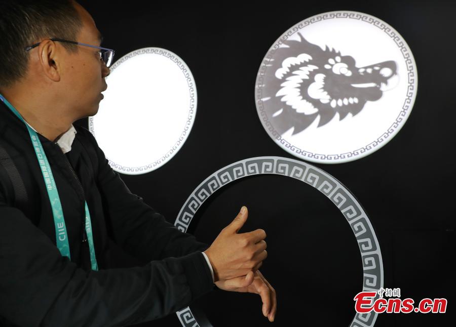 Using TensorFlow, an open source machine learning platform, Google’s ShadowPlay enables visitors to transform shadow figures from hand gestures into digital animations at the first China International Import Expo (CIIE) in Shanghai, east China, Nov. 7 2018. The installation, built using TensorFlow, uses AI to recognize a person’s hand gestures and then magically transform the shadow figure into digital animations representing the 12 animals of the Chinese zodiac and in an interactive show. (Photo: China News Service/Zhang Hengwei)